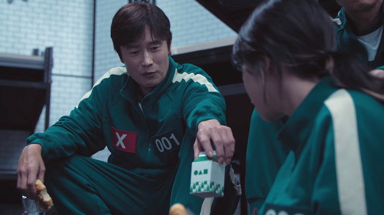 In-ho offering Kim Jun-hee his milk on "Squid Game" Season 2 (2024)