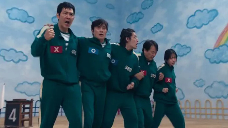 Gi-hun's team walks in the Six-Legged Pentathlon in "Squid Game"