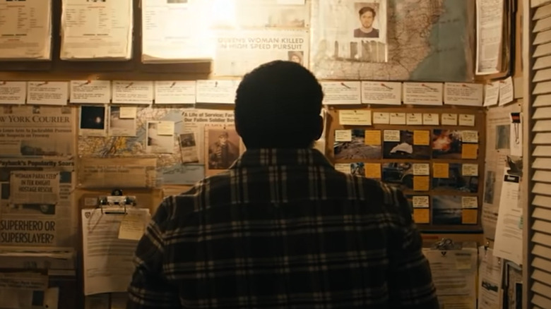 Man in front of newspapers