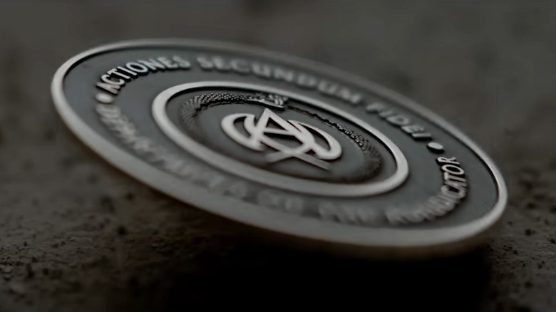 The Adjudicator's coin close-up