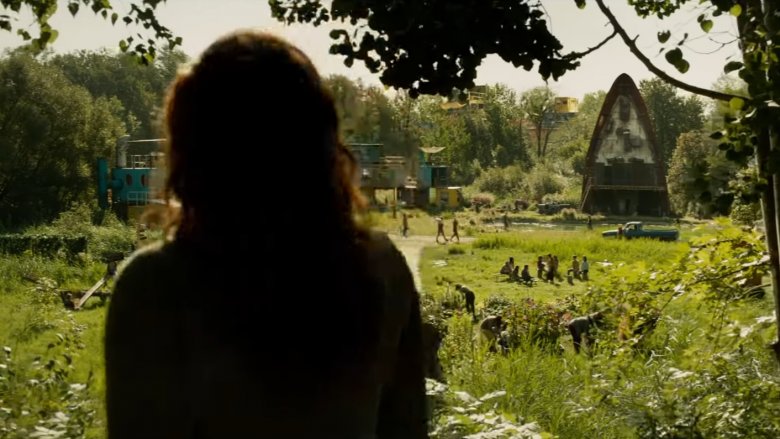 Jean Grey peers through trees at a strange island stronghold