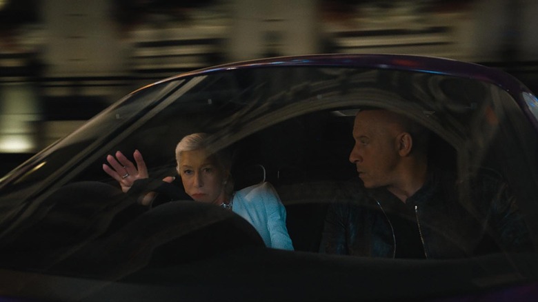Queenie driving with Dom in passenger seat
