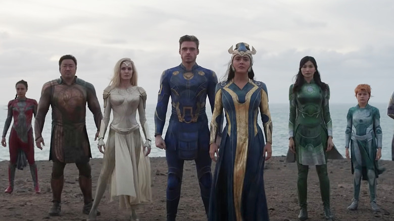 The Eternals standing on the beach in costume