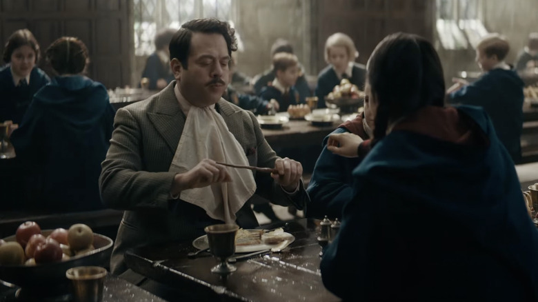 Jacob eating in Great Hall holding wand