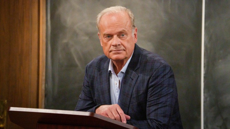 Frasier sitting at lectern