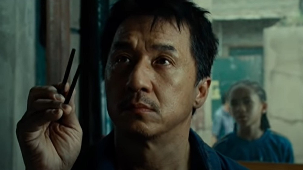 Jackie Chan as Mr. Han with a pair of chopsticks.