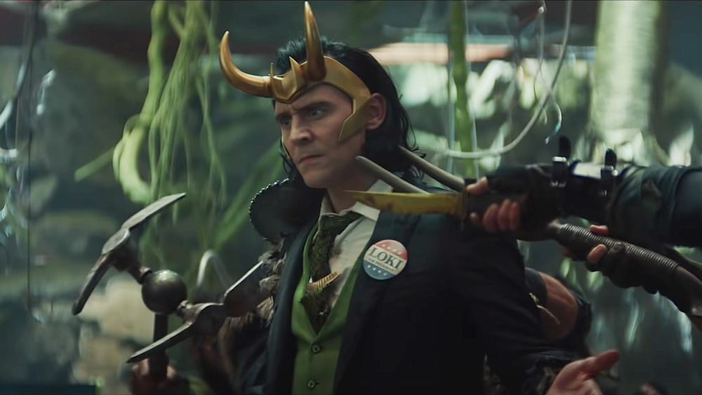 Loki with weapons at his neck