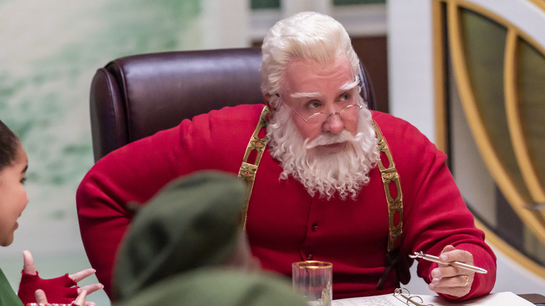 Santa confers with the elves