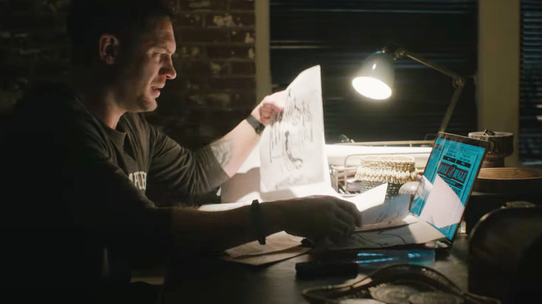 Eddie Brock with laptop open on Daily Bugle