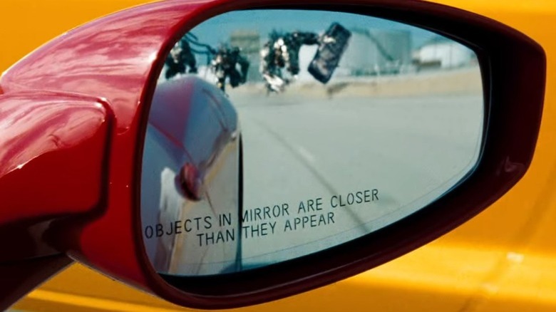 rampaging Decepticons reflected in a side-view car mirror