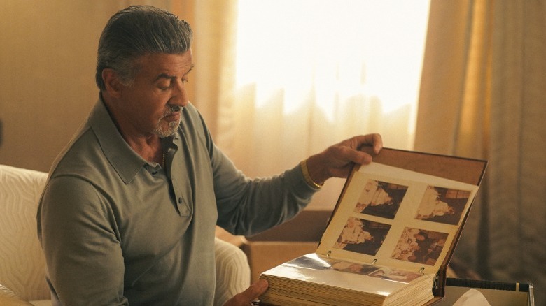 Sylvester Stallone looking through photobook