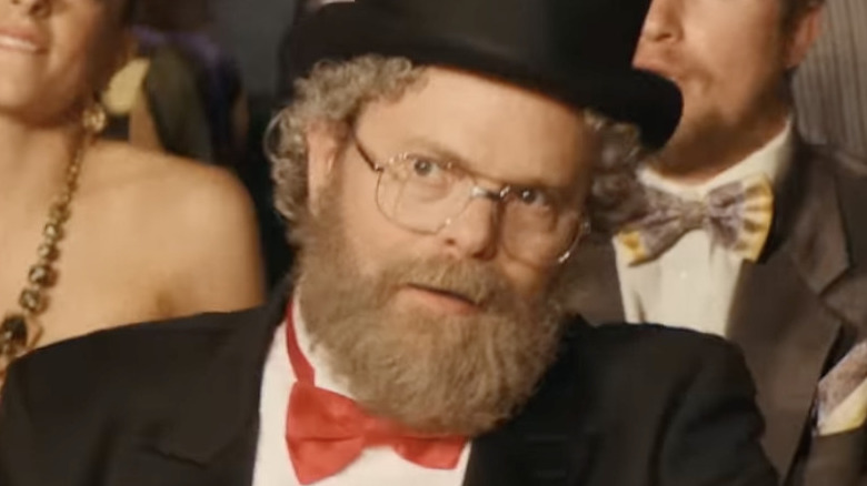 Rainn Wilson as Dr. Demento sits and watches