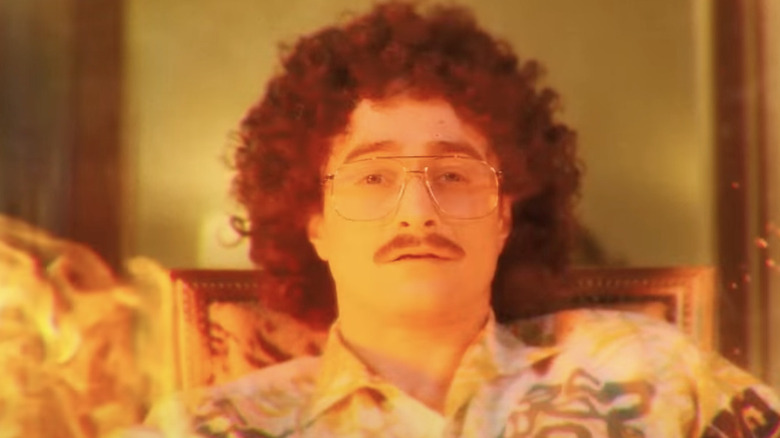 Daniel Radcliffe as "Weird Al" Yankovic bathed in orange light