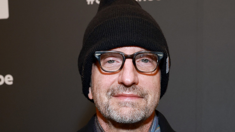 Steven Soderbergh wearing black hat