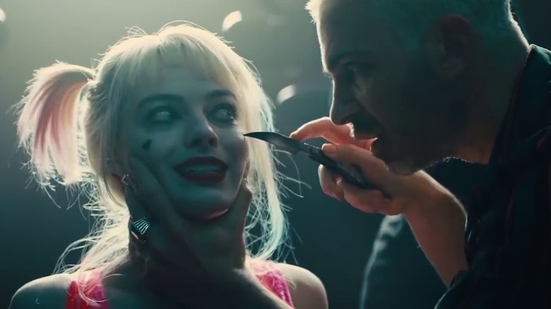 Harley Quinn nervously eyes knife