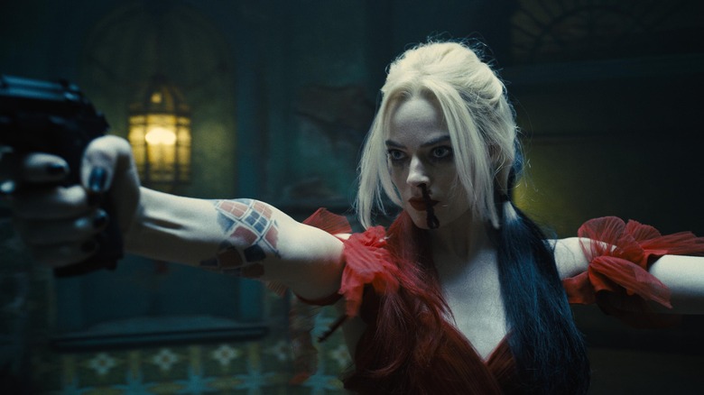 Harley Quinn aims a pistol