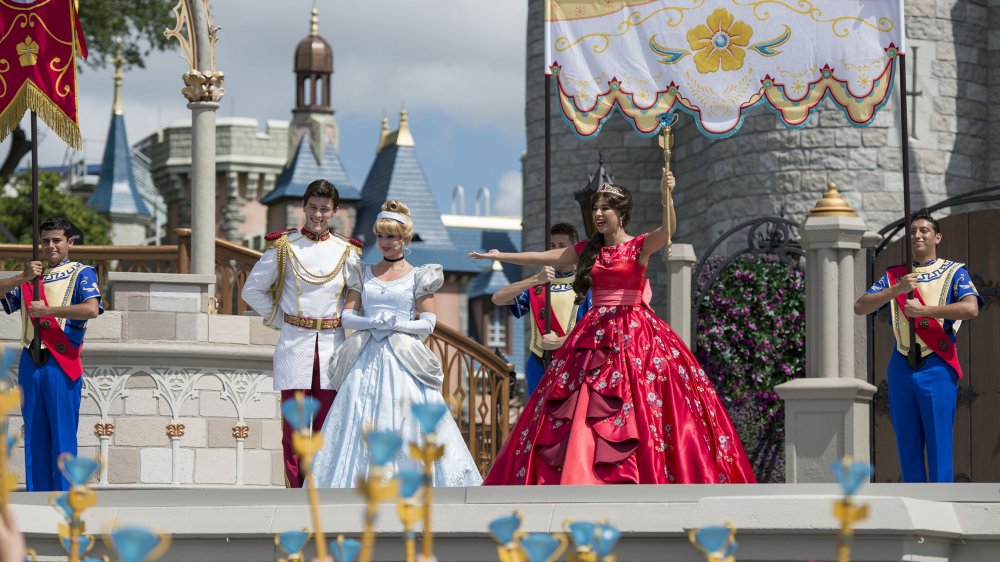 Cinderella, Prince Charming, and Elena of Avalor on the stage in front of Cinderella's Castle in Walt Disney World