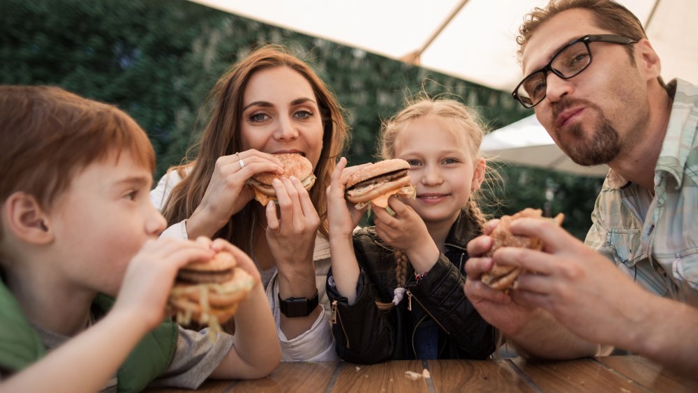 family eating burgers