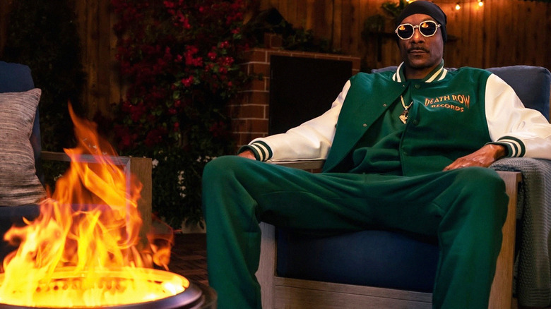 Snoop Dogg sitting by stove