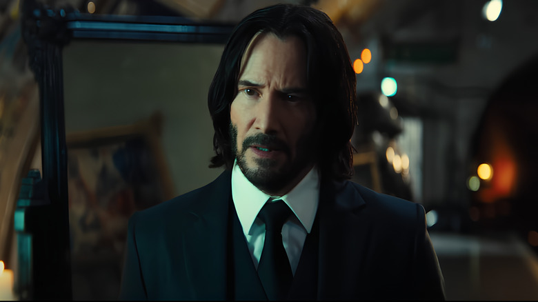 John Wick looking ahead wearing suit