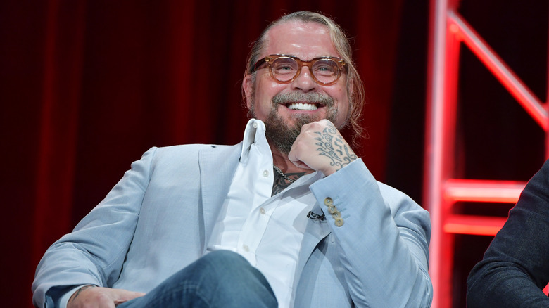 Kurt Sutter wearing a light blue blazer and glasses