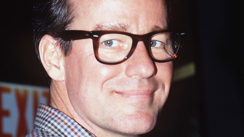 Phil Hartman wears glasses