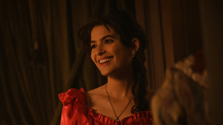 Lucia smiling in red dress