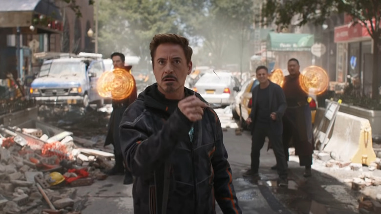 Dr. Strange, Tony Stark, Bruce Banner, and Wong stand in the street