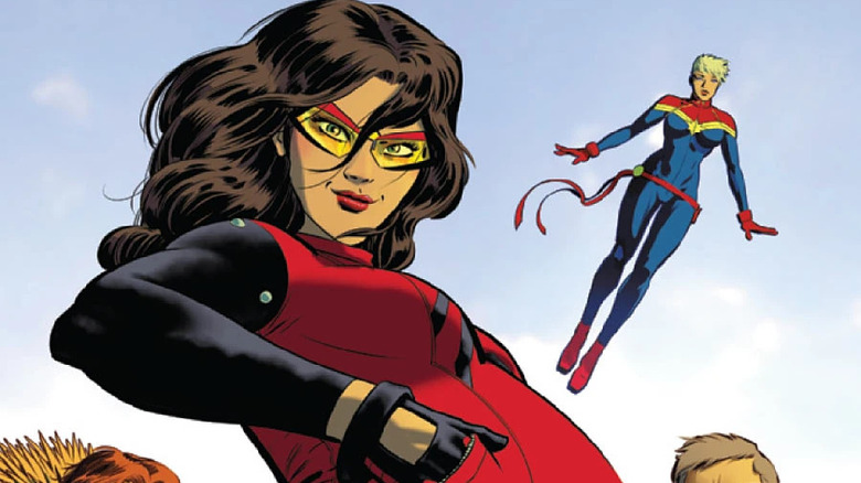 Spider-Woman standing in front of Captain Marvel