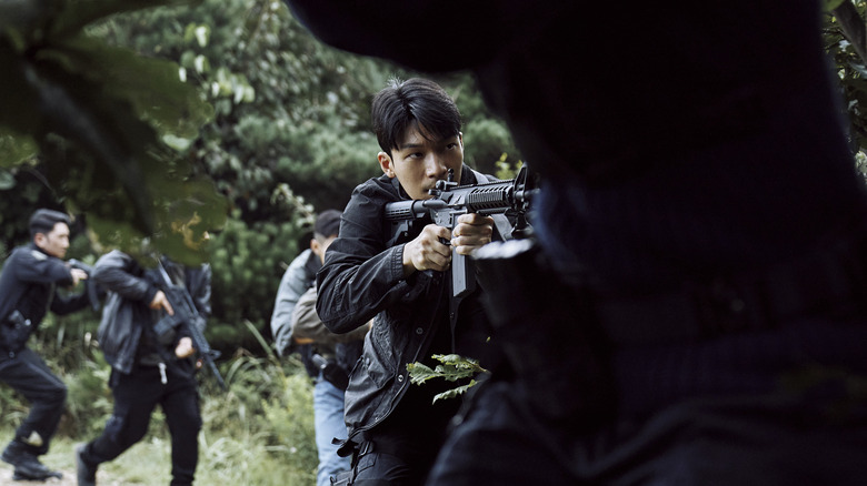 Wi Ha-joon as Hwang Jun-ho, moving the a forest with an armed militia on Squid Game