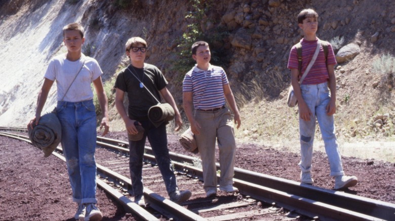 Stand By Kids walking on a railroad