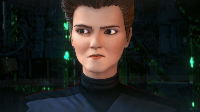 Holo Janeway stands in front of a screen showing a Borg Cube