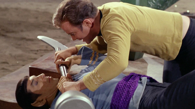 Kirk and Spock fight with a lirpa in Amok Time