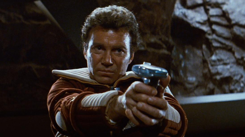 Kirk aims a phaser