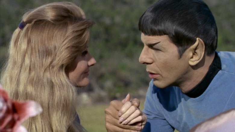 Leila Kalomi and Spock hold hands