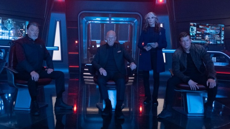 Picard, Riker, and other crew members in the captain's chambers