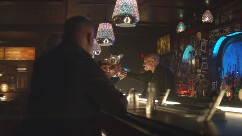 The crew toast at a bar 