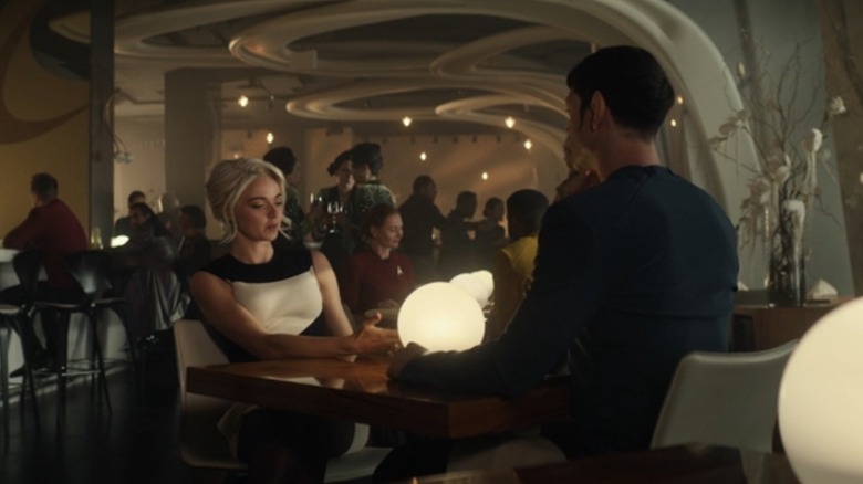 Christine and Spock sit at a restaurant table