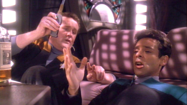 Bashir and O'Brien drink on the couch