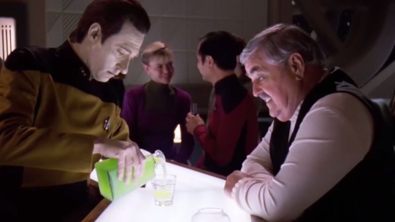 Data pouring Scotty a drink