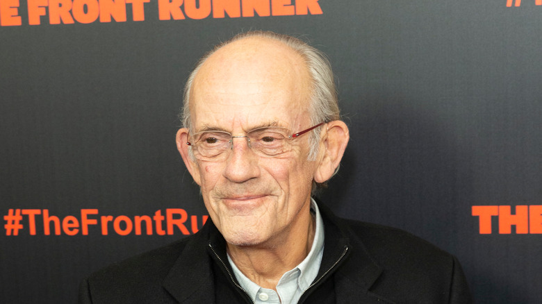 Christopher Lloyd wearing glasses smiling