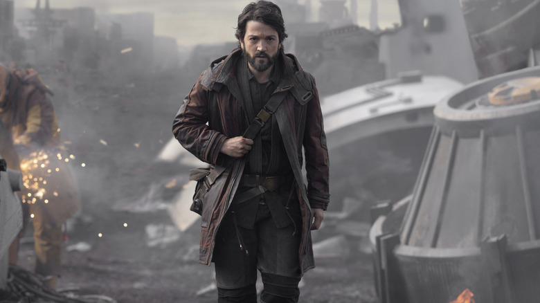 Cassian Andor walks through a junkyard