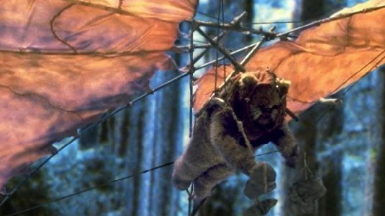 A hang-gliding Ewok dropping stones