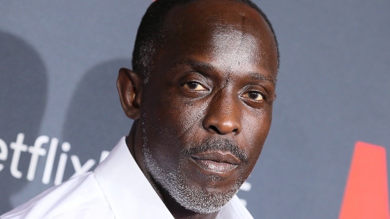 Michael Kenneth Williams in a white shirt on the red carpet