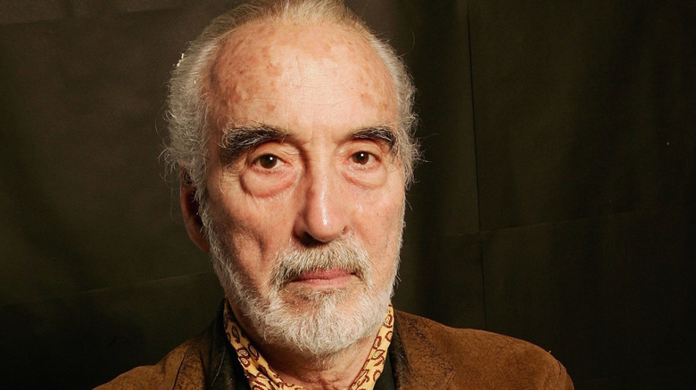 Christopher Lee wearing a brown jacket