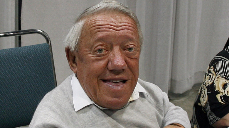 Kenny Baker sitting at table