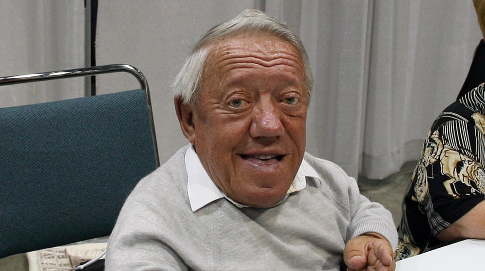 Kenny Baker sitting at table