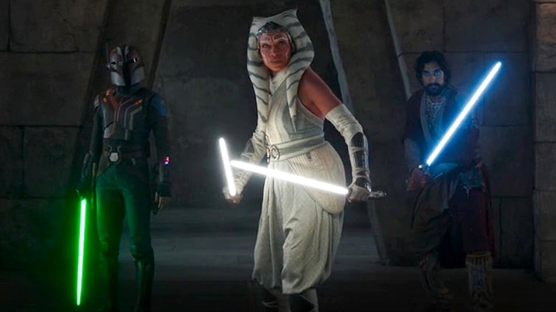 Ahsoka, Sabine, and Ezra wielding their lightsabers 