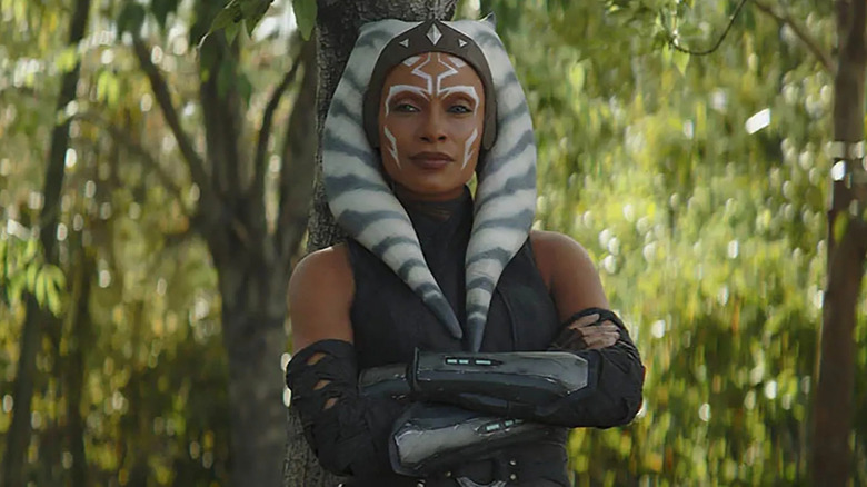 Ahsoka leaning against a tree