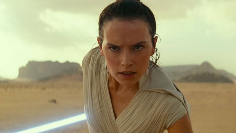 Rey holding lightsaber